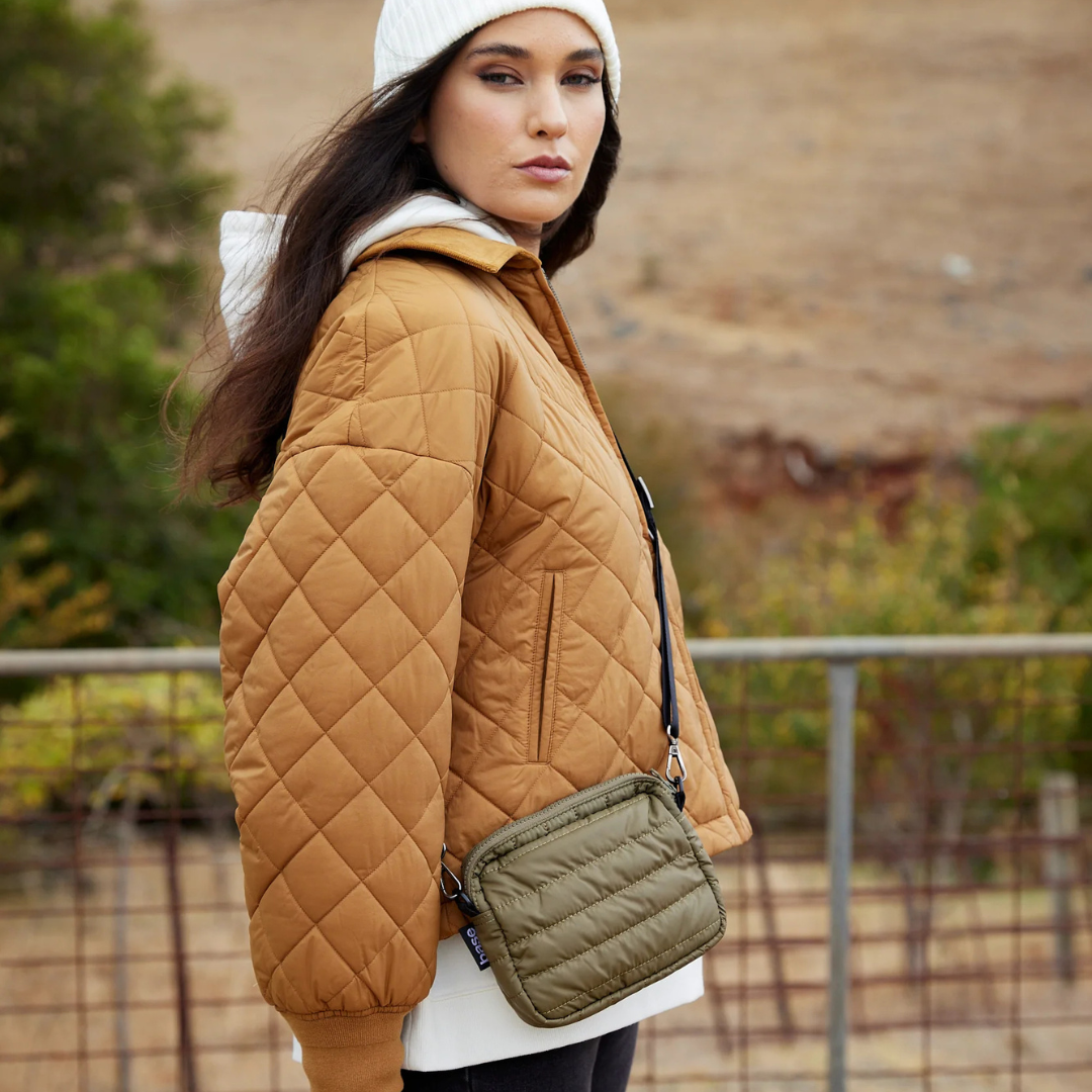 Mini Base Cloud Bag - a small crossbody bag in soft, cloud-like fabric - khaki bag pictured being worn across the body resting on the hip - Stocked at LOVINLIFE Co Byron Bay for all your gifts, candles and interior decorating needs