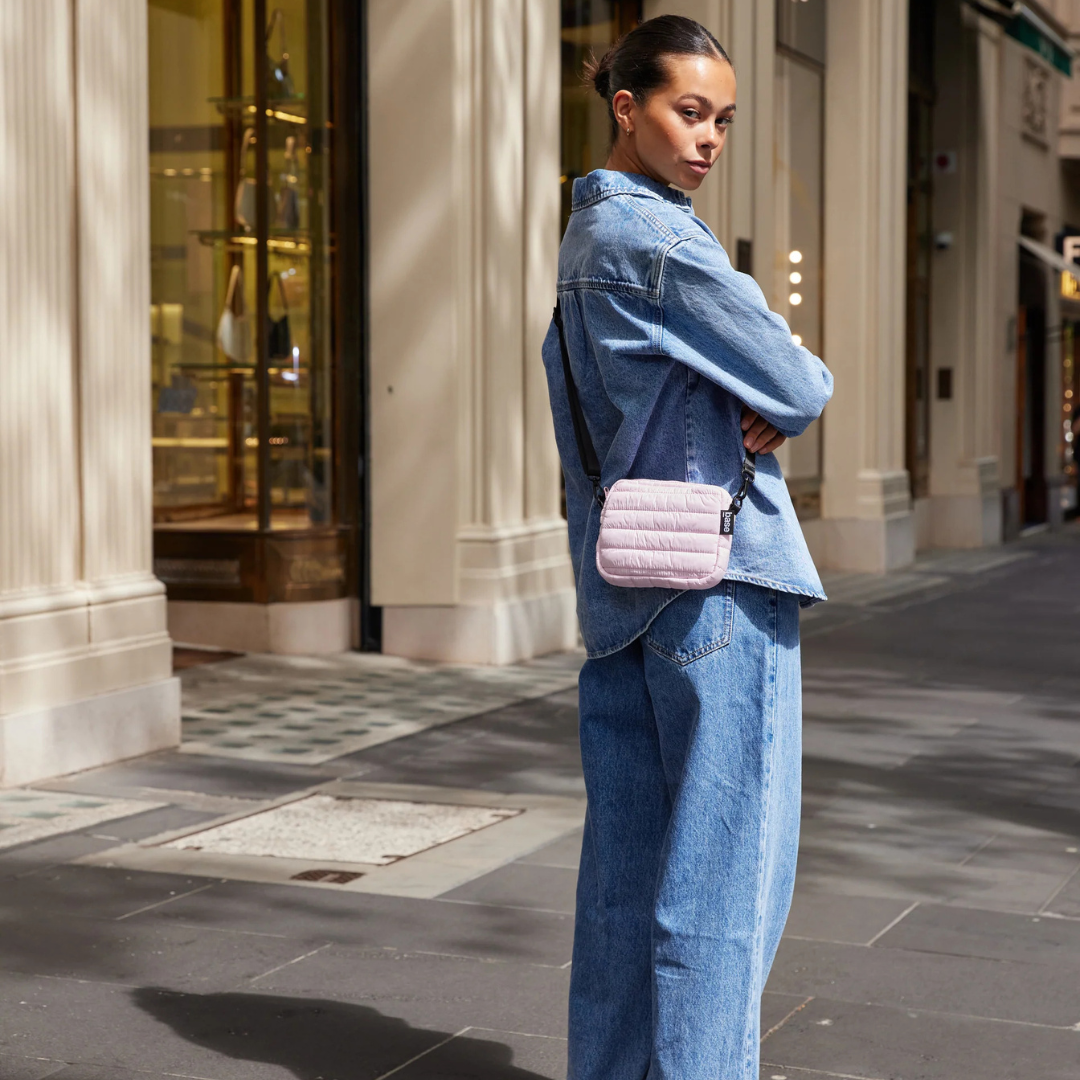 Mini Base Cloud Bag - a small crossbody bag in soft, cloud-like fabric - peony bag pictured being worn across the body on the back hip - Stocked at LOVINLIFE Co Byron Bay for all your gifts, candles and interior decorating needs