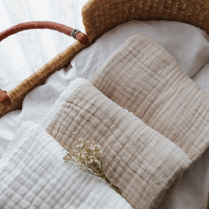 flat lay of 3 organic muslin cotton baby blankets in different neutral shades folded and lying in a baby's crib. Stocked at LOVINLIFE Co Byron Bay for all your gifts, candles and interior decorating needs