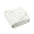 Folded organic muslin cotton baby blanket in white on a white background. Stocked at LOVINLIFE Co Byron Bay for all your gifts, candles and interior decorating needs