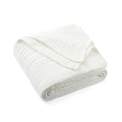 Folded organic muslin cotton baby blanket in white on a white background. Stocked at LOVINLIFE Co Byron Bay for all your gifts, candles and interior decorating needs