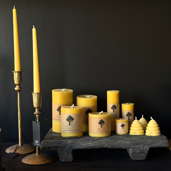 Collection of 100% pure beeswax candles, made with 100% pure cotton wicks, and candle holders on a dark background. Stocked at LOVINLIFE Co Byron Bay for all your gifts, candles and interior decorating needs