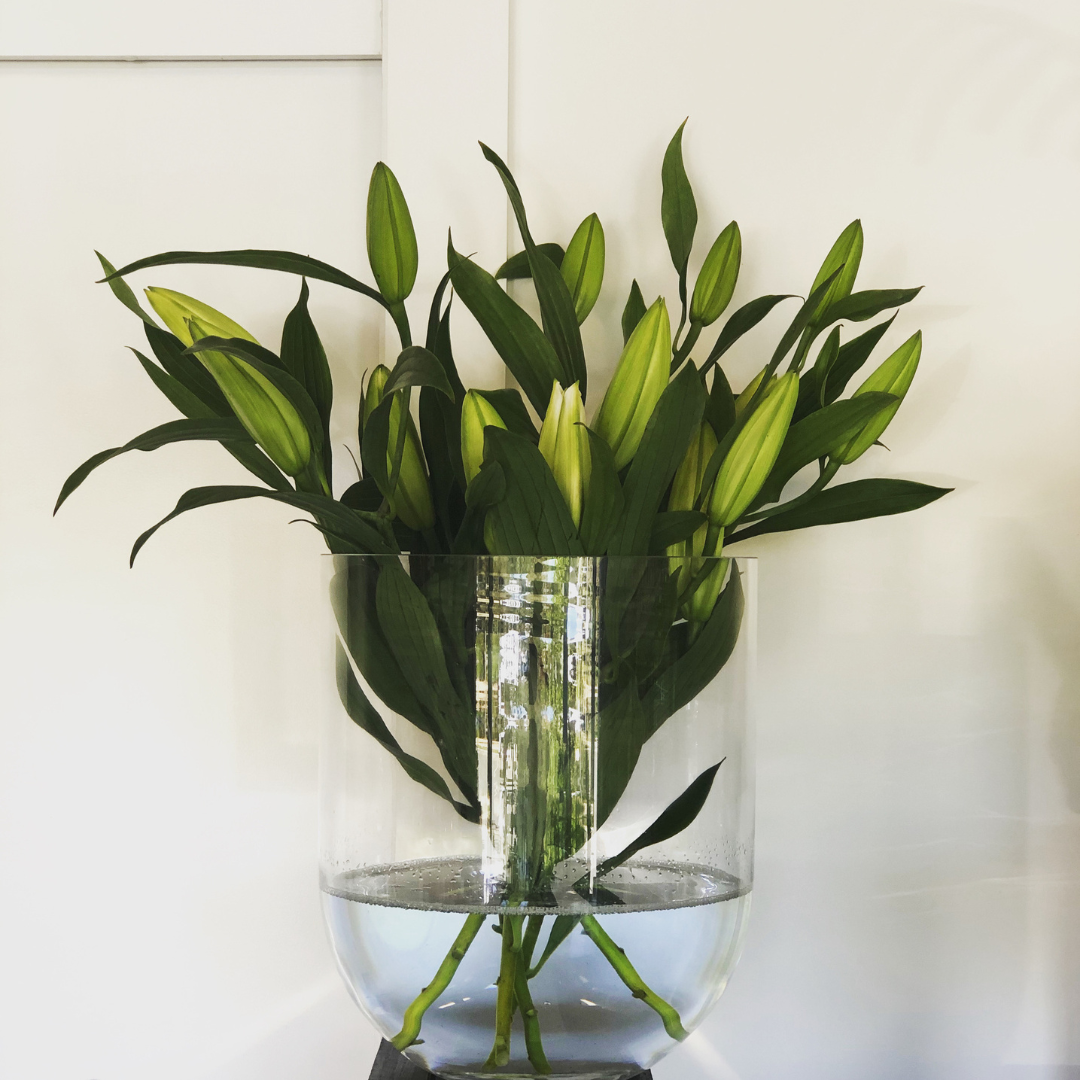 Round Base Candle Holder / Vase from Francalia in Clear, pictured holding a bunch of lillies - Stocked at LOVINLIFE Co Byron Bay for all your gifts, candles and interior decorating needs