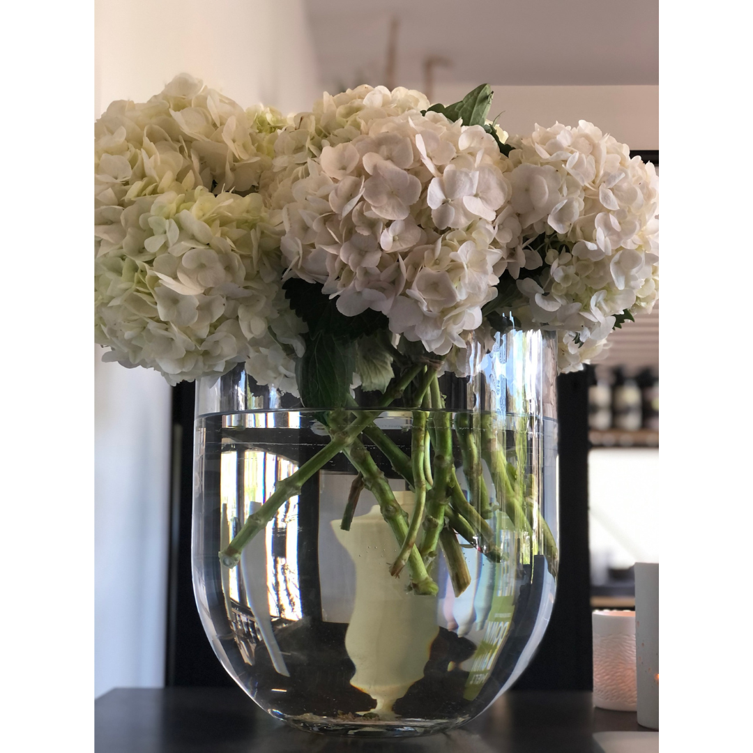 Round Base Candle Holder / Vase from Francalia in Clear, pictured holding a bunch of white hydrangeas - Stocked at LOVINLIFE Co Byron Bay for all your gifts, candles and interior decorating needs