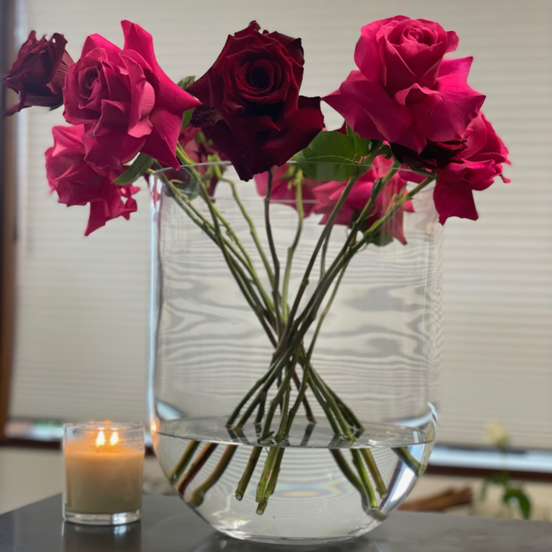 Round Base Candle Holder / Vase from Francalia in Clear, pictured sitting on a shelf holding pink roses - Stocked at LOVINLIFE Co Byron Bay for all your gifts, candles and interior decorating needs