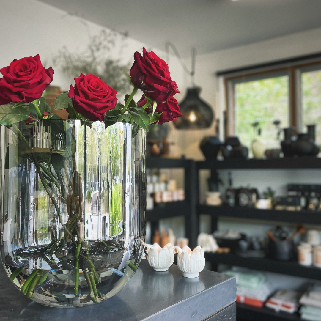 Round Base Candle Holder / Vase from Francalia in Lustre Black, pictured with red roses in foreground, and the shop in the background - Stocked at LOVINLIFE Co Byron Bay for all your gifts, candles and interior decorating needs