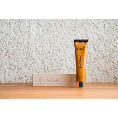 Lovinlife Co ByronBay – Saarde Saint-Raphaël hand and body moisturiser - orange blossom, saffron, lemon and cinnamon scents – pictured on wooden bench with box - available at LOVINLIFE Co Byron Bay for all your gifts, candles and interior decorating needs