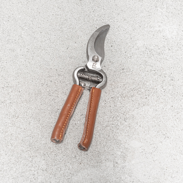 Garden secateurs, pictured closed, made with drop-forged stainless steel blades and handles beautifully wrapped in natural leather - Available at LOVINLIFE Co Byron Bay