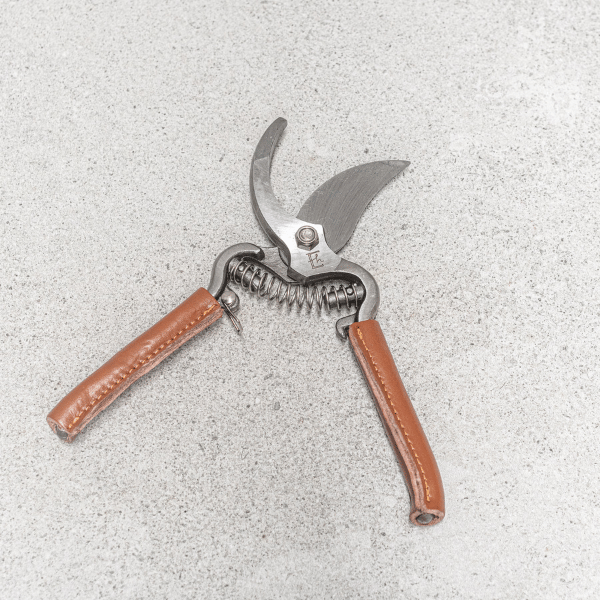 Garden secateurs, pictured open, made with drop-forged stainless steel blades and handles beautifully wrapped in natural leather - Available at LOVINLIFE Co Byron Bay
