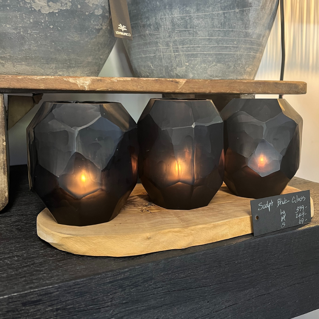 Indigo Love Sculpt Black Vases - Small - high-quality opaque black glass with polygon shapes and geometric design - art that doubles as a functional vase or tealight lantern - shown on display in shop with tealight candles inside - Stocked at LOVINLIFE Co Byron Bay for all your gifts, candles and interior decorating needs