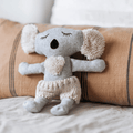 Soft Toy Koala called Bernard, resting on a cushion, made from beautifully soft wool-blend fabric with the cosiest cream knitted pants in Australian merino wool - Available at LOVINLIFE Co Byron Bay