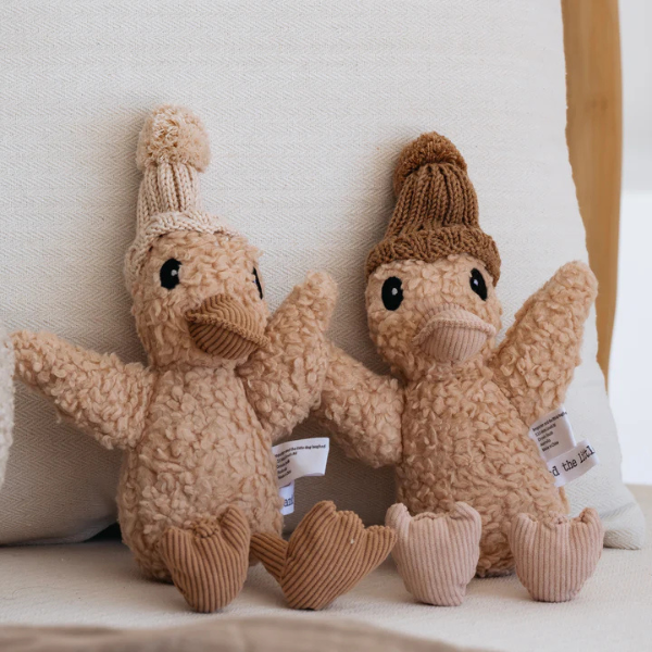Two Soft Toy Ducks sitting on a couch made from a unique cotton plush fabric with caramel corduroy accents and Australian merino wool knitted beanie - Duck Edmond & Duck Petunia - Available at LOVINLIFE Co Byron Bay