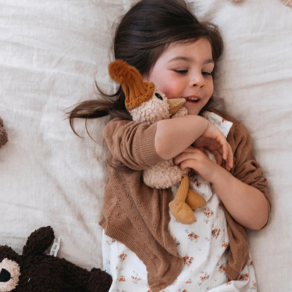 Girl hugging her Soft Toy Duck made from a unique cotton plush fabric with caramel corduroy accents and Australian merino wool knitted beanie - Duck Petunia - Available at LOVINLIFE Co Byron Bay