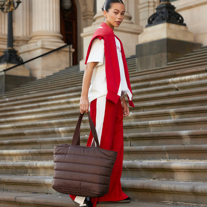 Take it Base Bag - A large soft-as-a-cloud shoulder bag for days on the go or weekends away - Chocolate bag pictured being carried by the handle - Stocked at LOVINLIFE Co Byron Bay for all your gifts, candles and interior decorating needs