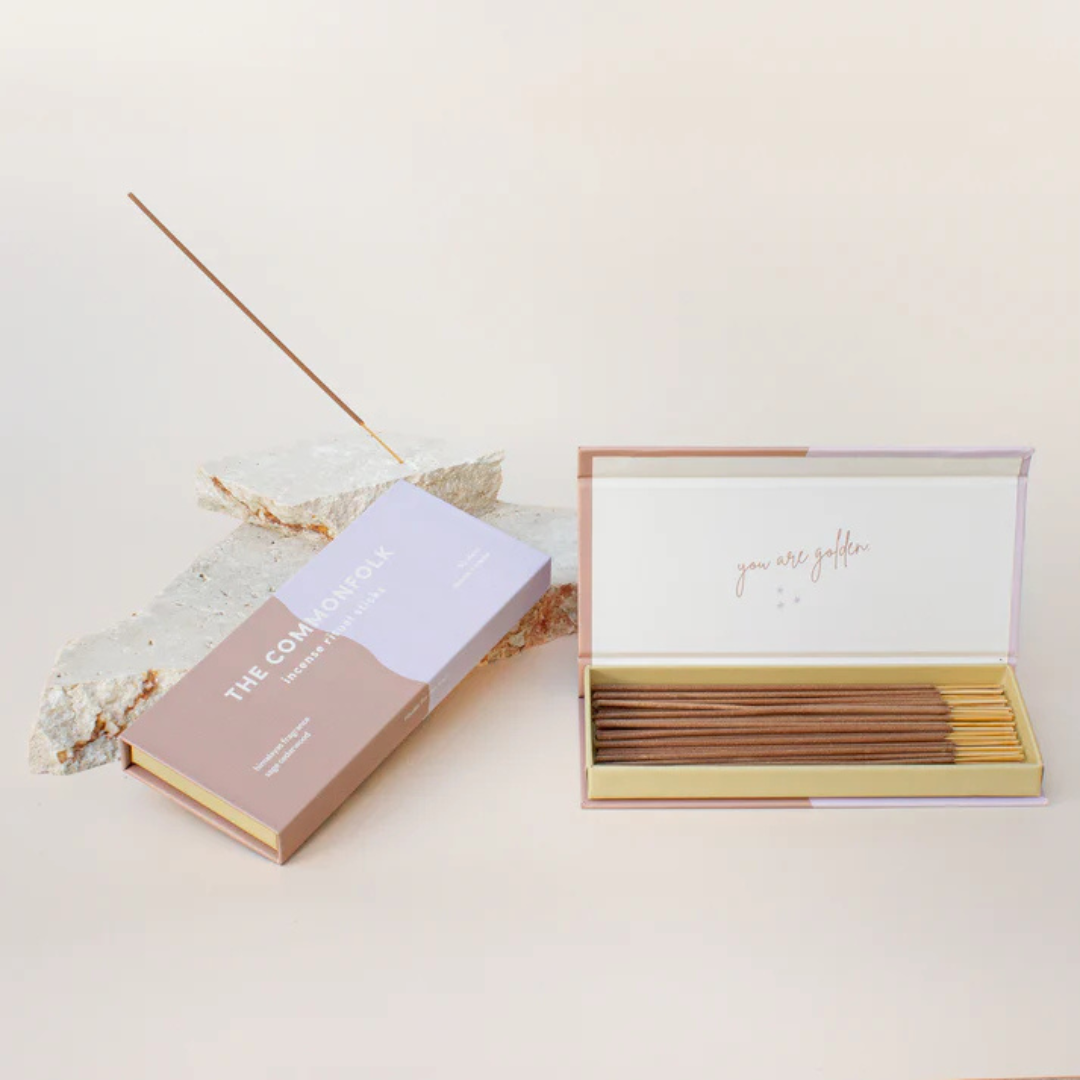 Commonfolk Incense Ritual Sticks - Himalayas scent with Sage and Cedarwood - open box pictured next to closed box and stick being held in rock incense holder - Stocked at LOVINLIFE Co Byron Bay for all your gifts, candles and interior decorating needs