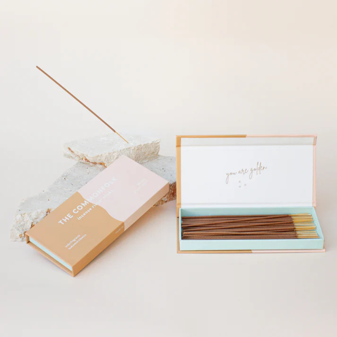 Commonfolk Incense Ritual Sticks - India scent with teakwood and tobacco - open box pictured next to closed box and stick being held in rock incense holder - Stocked at LOVINLIFE Co Byron Bay for all your gifts, candles and interior decorating needs