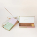 Commonfolk Incense Ritual Sticks - Ubud scent with Agarwood, Musk and Patchouli - open box pictured next to closed box and stick being held in rock incense holder - Stocked at LOVINLIFE Co Byron Bay for all your gifts, candles and interior decorating needs