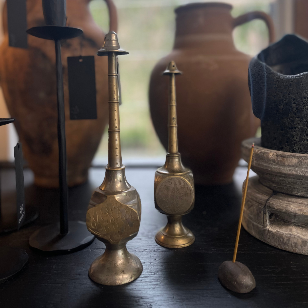 Vintage Indian Perfume Bottles next to smoking incense stick on display at LOVINLIFE Co Byron Bay for all your gifts, candles and interior decorating needs