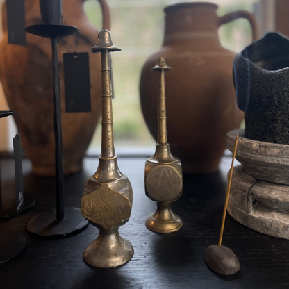 Vintage Indian Perfume Bottles next to smoking incense stick on display at LOVINLIFE Co Byron Bay for all your gifts, candles and interior decorating needs