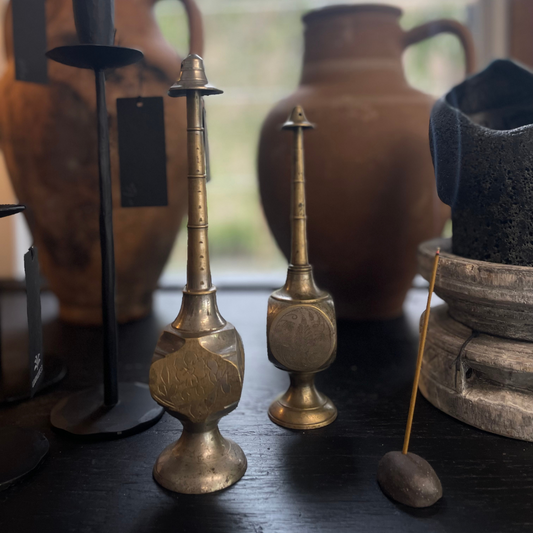 Vintage Indian Perfume Bottles next to smoking incense stick on display at LOVINLIFE Co Byron Bay for all your gifts, candles and interior decorating needs