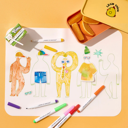 Wipeable Silicone Colouring Mat - FRIENDS - pictured being coloured in, next to a juice box and lunch box with orange segments inside - Stocked at LOVINLIFE Co Byron Bay for all your gifts, candles and interior decorating needs