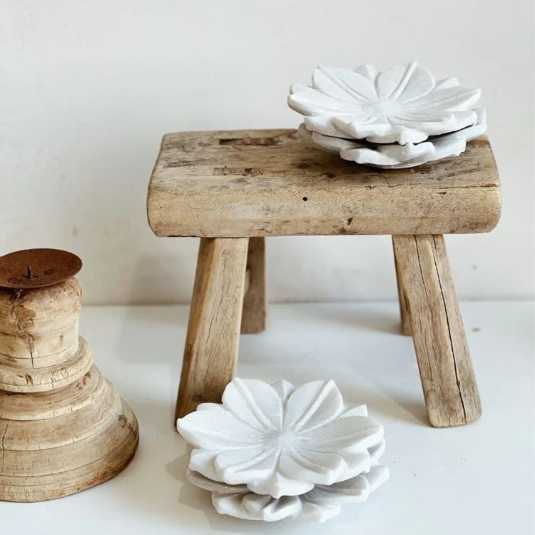 Barefoot Gypsy - White Marble Lotus Plates - stacked on and near a wooden display stand - Stocked at LOVINLIFE Co Byron Bay for all your gifts, candles and interior decorating needs