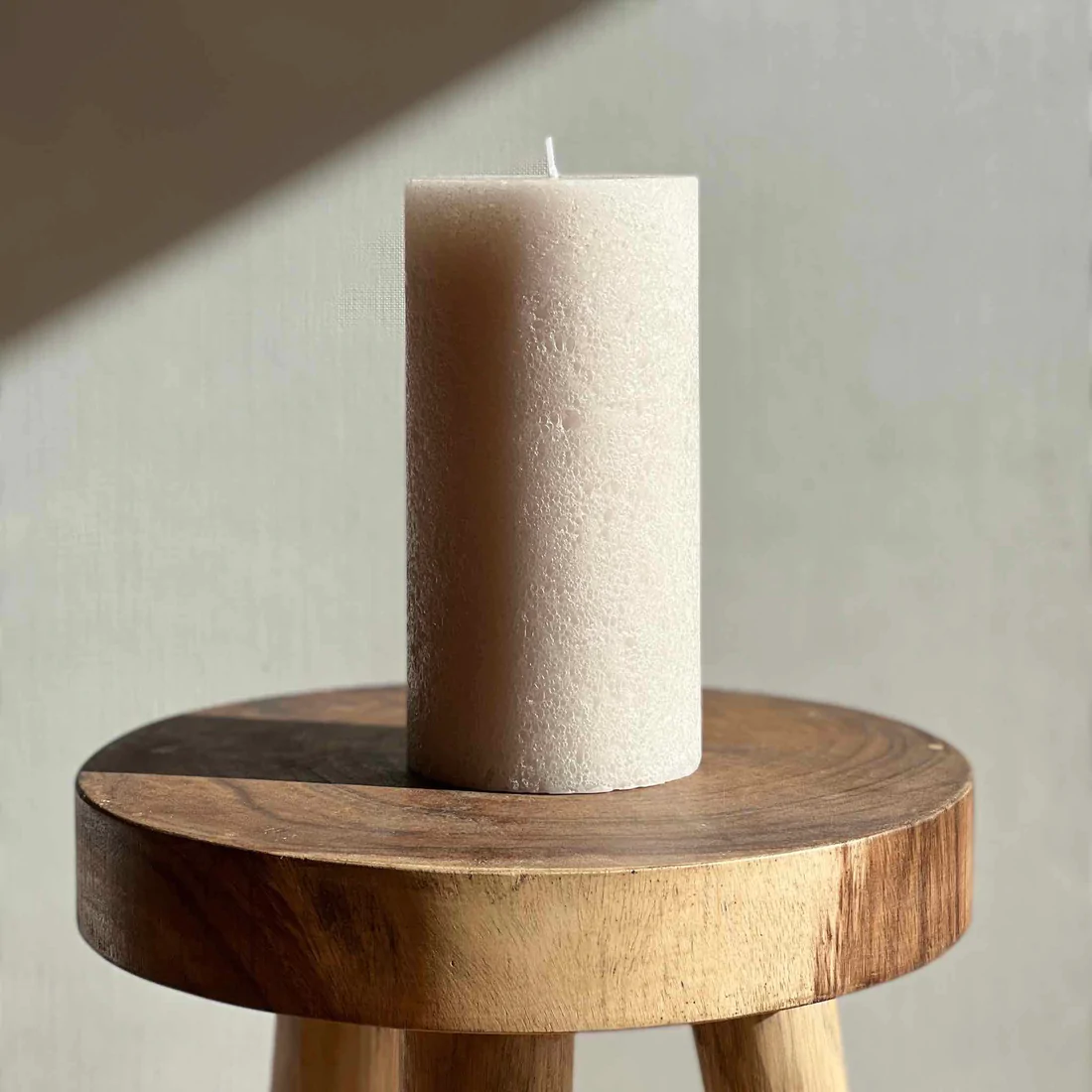 Candle Kiosk - Textured Sandstone Pillar Candles - medium candle on wood stool - Stocked at LOVINLIFE Co Byron Bay for all your gifts, candles and interior decorating needs