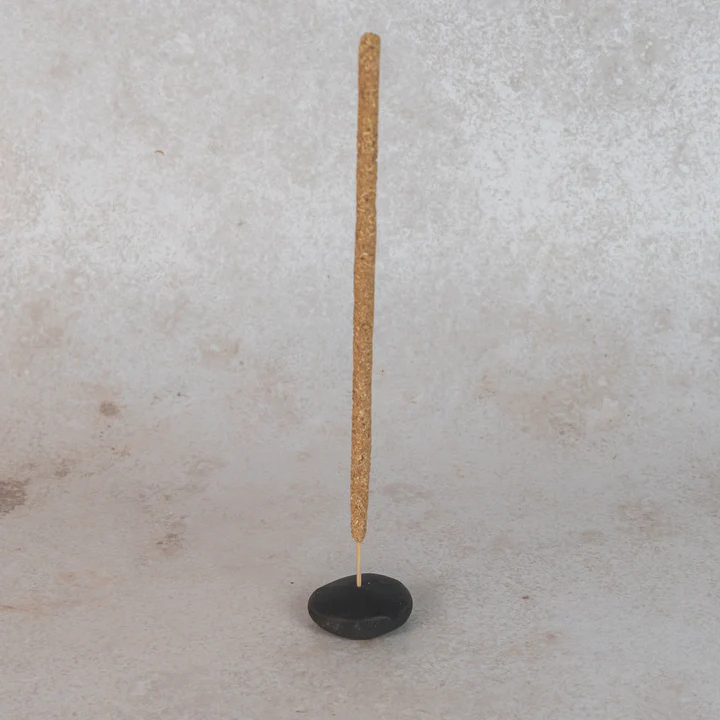 Cedar and Myrrh Lavender Flower Hand Rolled Incense Stick - pictured being held by black clay pebble incense holder - Stocked at LOVINLIFE Co Byron Bay for all your gifts, candles and interior decorating needs