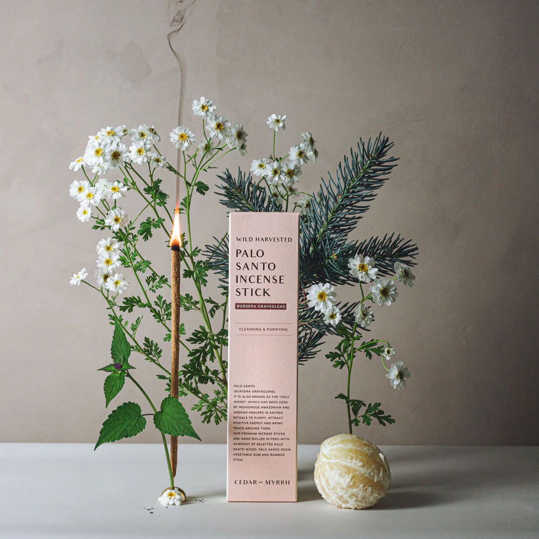 Cedar and Myrrh Palo Santo Hand Rolled Incense Stick - pictured alight next to box and flowers, mandarin and fir needles - Stocked at LOVINLIFE Co Byron Bay for all your gifts, candles and interior decorating needs
