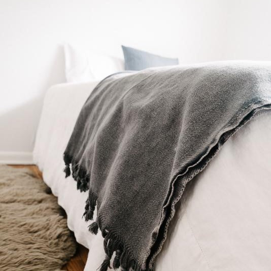 Saarde's Vintage Wash 100% OEKO-TEX® Turkish Cotton Throw Blanket in Charcoal – Pictured on the ends of a bed - available at LOVINLIFE Co Byron Bay for all your gifts, candles and interior decorating needs