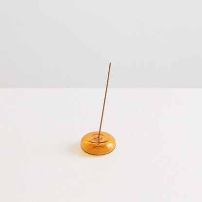 Maison Balzac Le Galet, or the pebble, is a playful and minimal bubble of 100% Borosilicate glass hand blown into a modern incense stick holder - amber glass pebbles with incense stick - Stocked at LOVINLIFE Co Byron Bay for all your gifts, candles and interior decorating needs