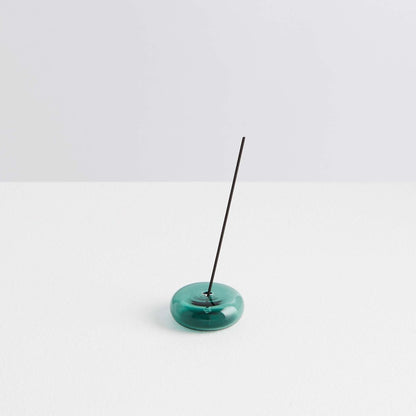 Maison Balzac Le Galet, or the pebble, is a playful and minimal bubble of 100% Borosilicate glass hand blown into a modern incense stick holder - teal glass pebbles with incense stick - Stocked at LOVINLIFE Co Byron Bay for all your gifts, candles and interior decorating needs
