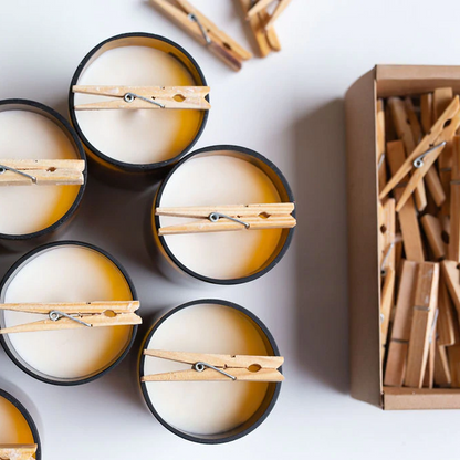 Commonfolk Dictionary Candle's being made with pegs - amber glass jars pictured from above as setting - Stocked at LOVINLIFE Co Byron Bay for all your gifts, candles and interior decorating needs